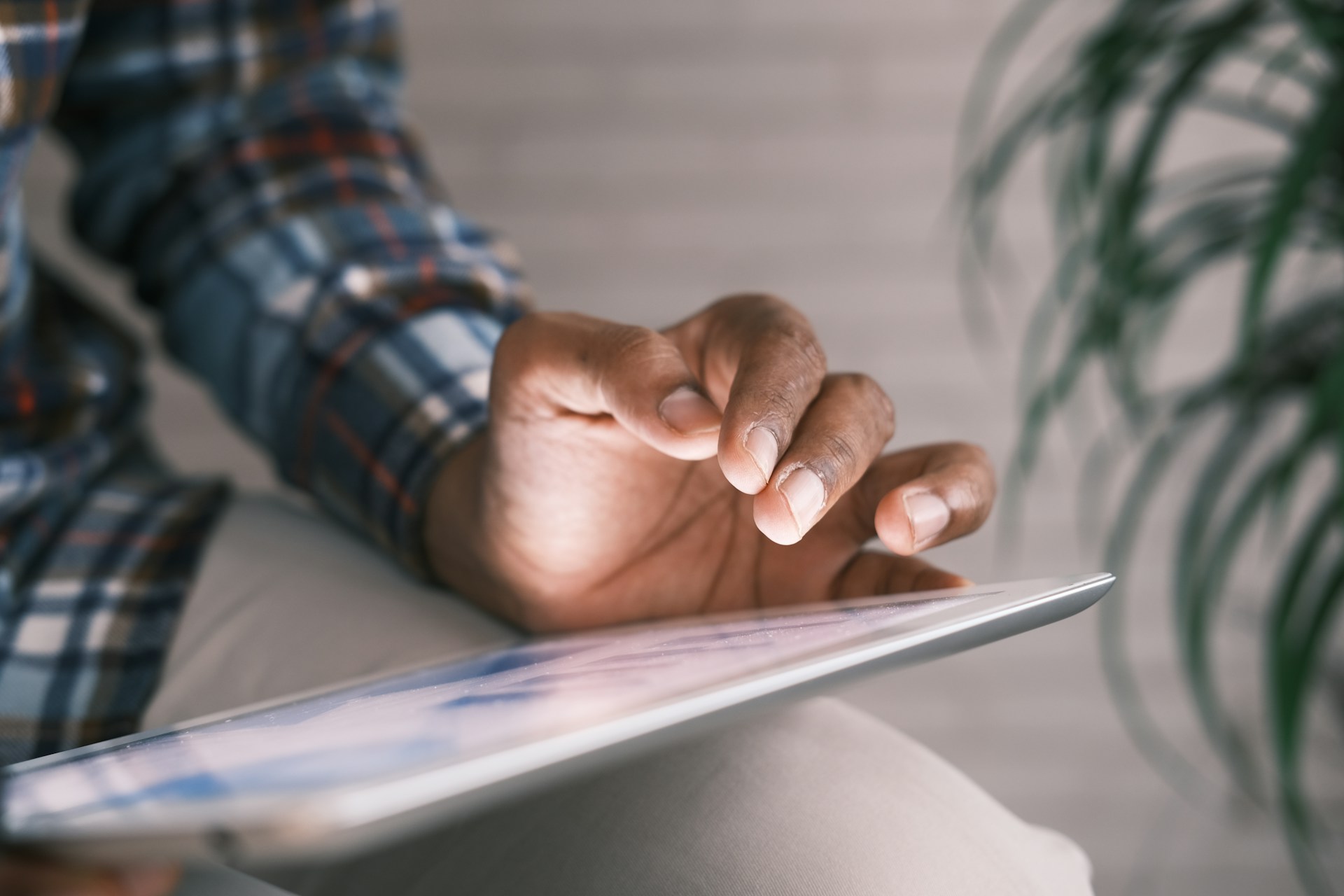 A person looking at information on a tablet screen.